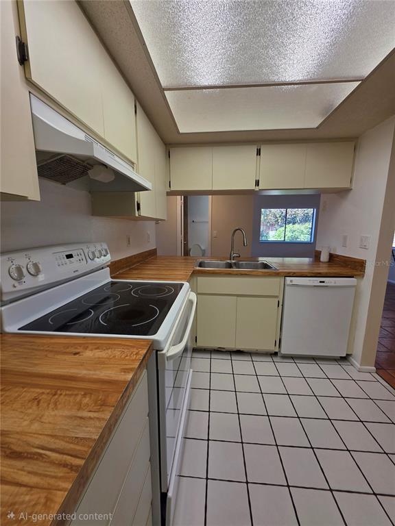 9000 Griggs Road, Unit G Englewood, FL 34224 - Photo 18 of 24 a kitchen with a sink a stove top oven and cabinets