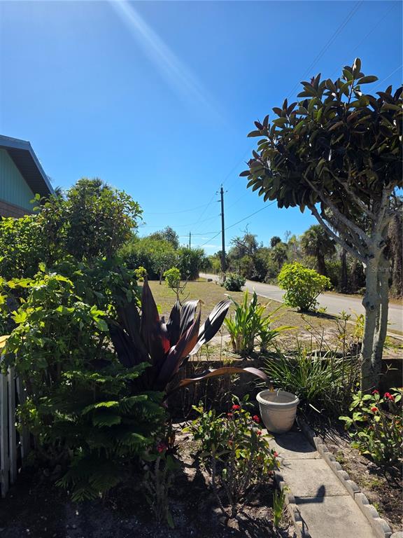 9000 Griggs Road, Unit G Englewood, FL 34224 - Photo 24 of 24 a view of a garden with plants and a bench