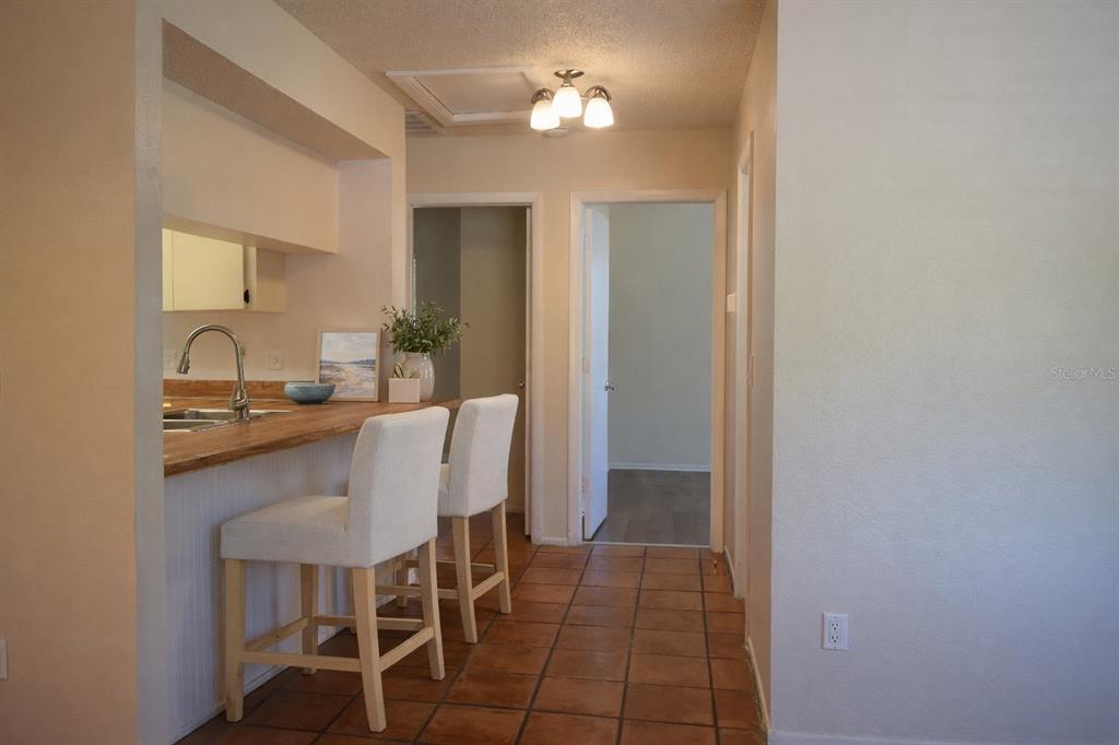 9000 Griggs Road, Unit G Englewood, FL 34224 - Photo 7 of 24 a view of a dining room with furniture and chandelier