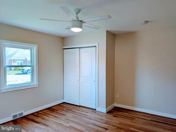 a bathroom with a toilet and a mirror