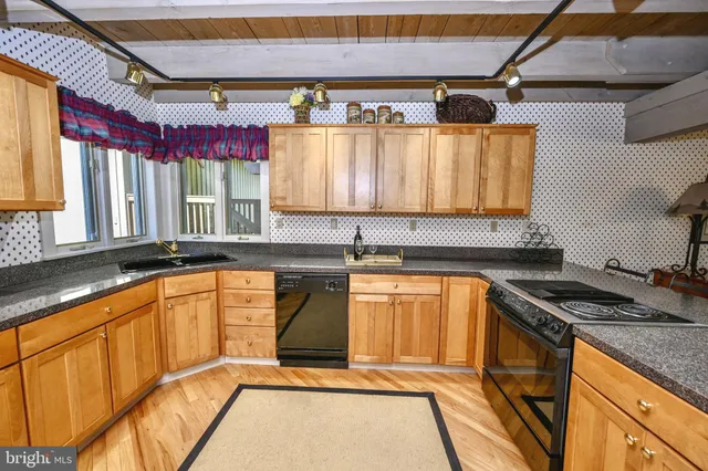 a bedroom with a bed a dresser and potted plant
