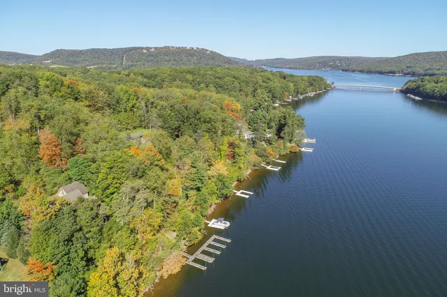 a living room with furniture large window and a fireplace