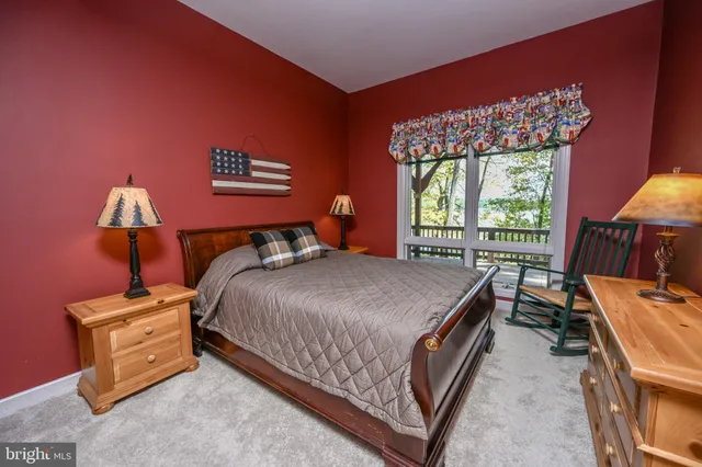 an aerial view of a house with a yard and lake view