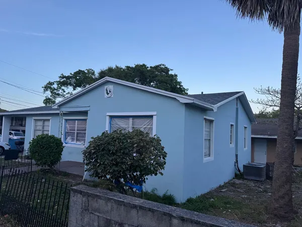 a house that has a tree in front of it