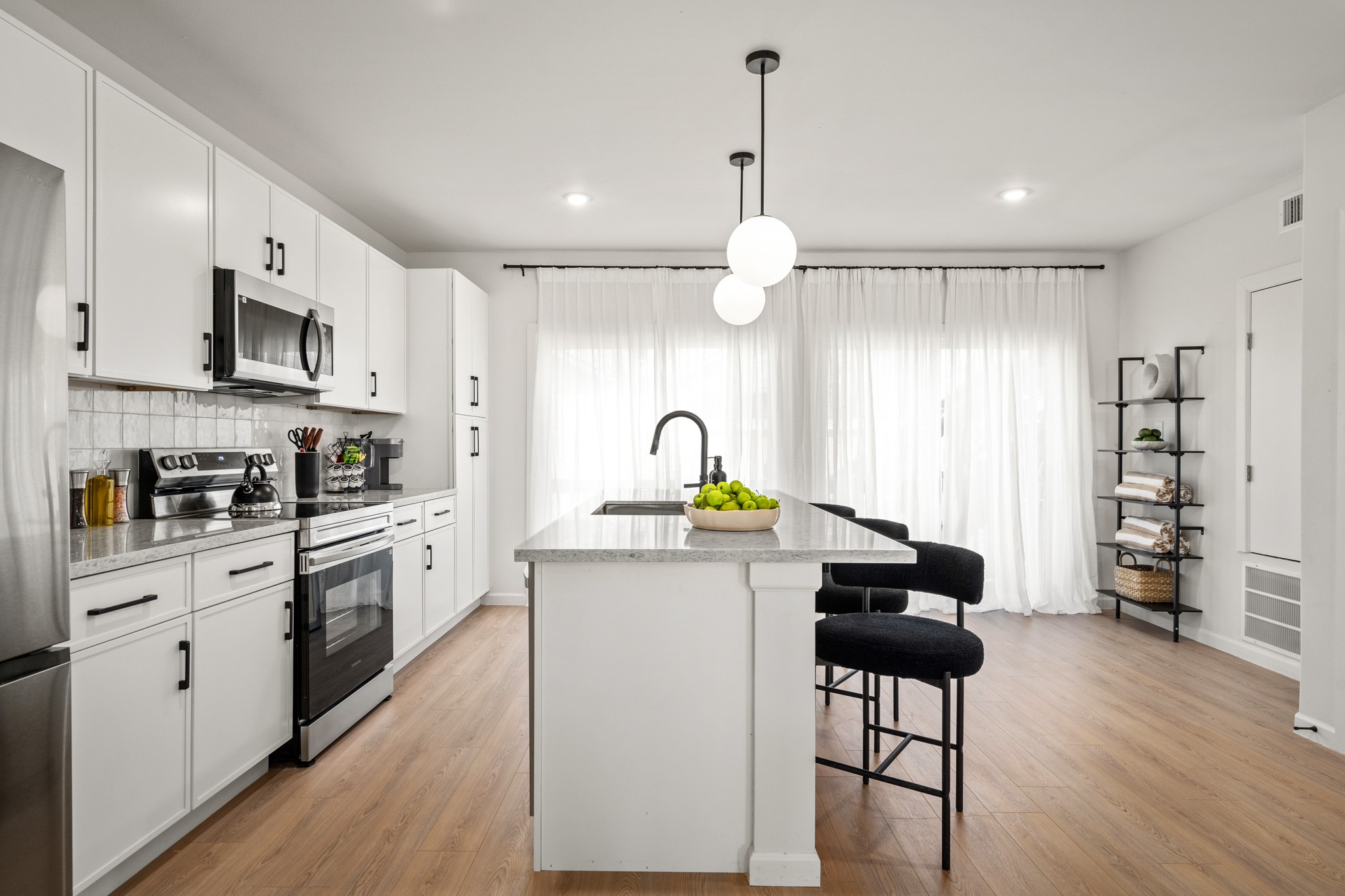 2413 Isabella Street Houston, TX 77004 - Photo 11 of 50 a kitchen with stainless steel appliances a stove a sink cabinets and wooden floor