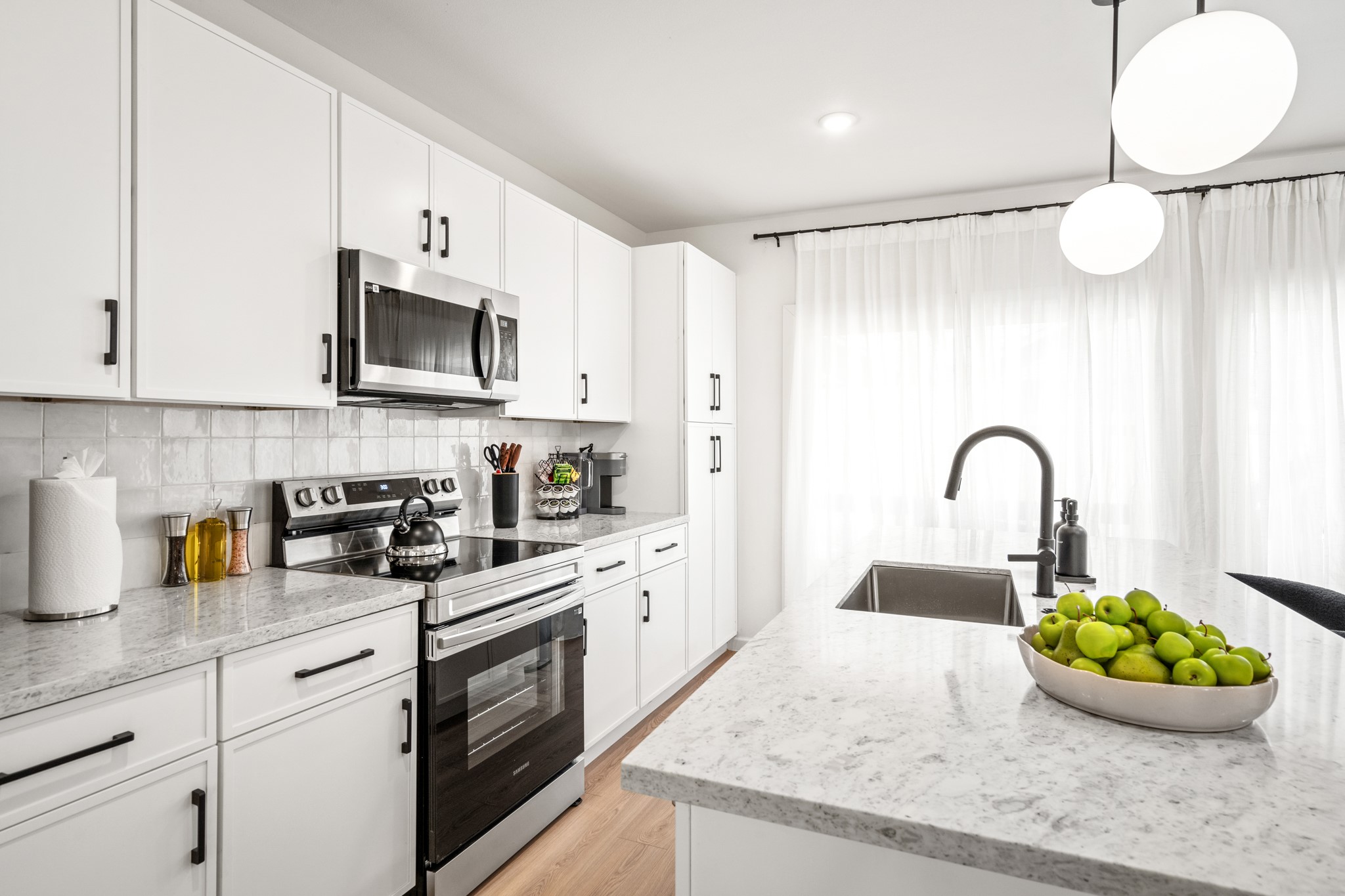 2413 Isabella Street Houston, TX 77004 - Photo 12 of 50 a kitchen with a sink a stove and cabinets