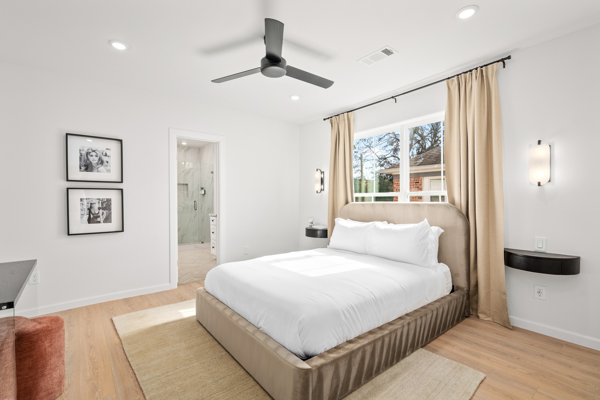 2413 Isabella Street Houston, TX 77004 - Photo 20 of 50 a bedroom with a large bed and a chandelier