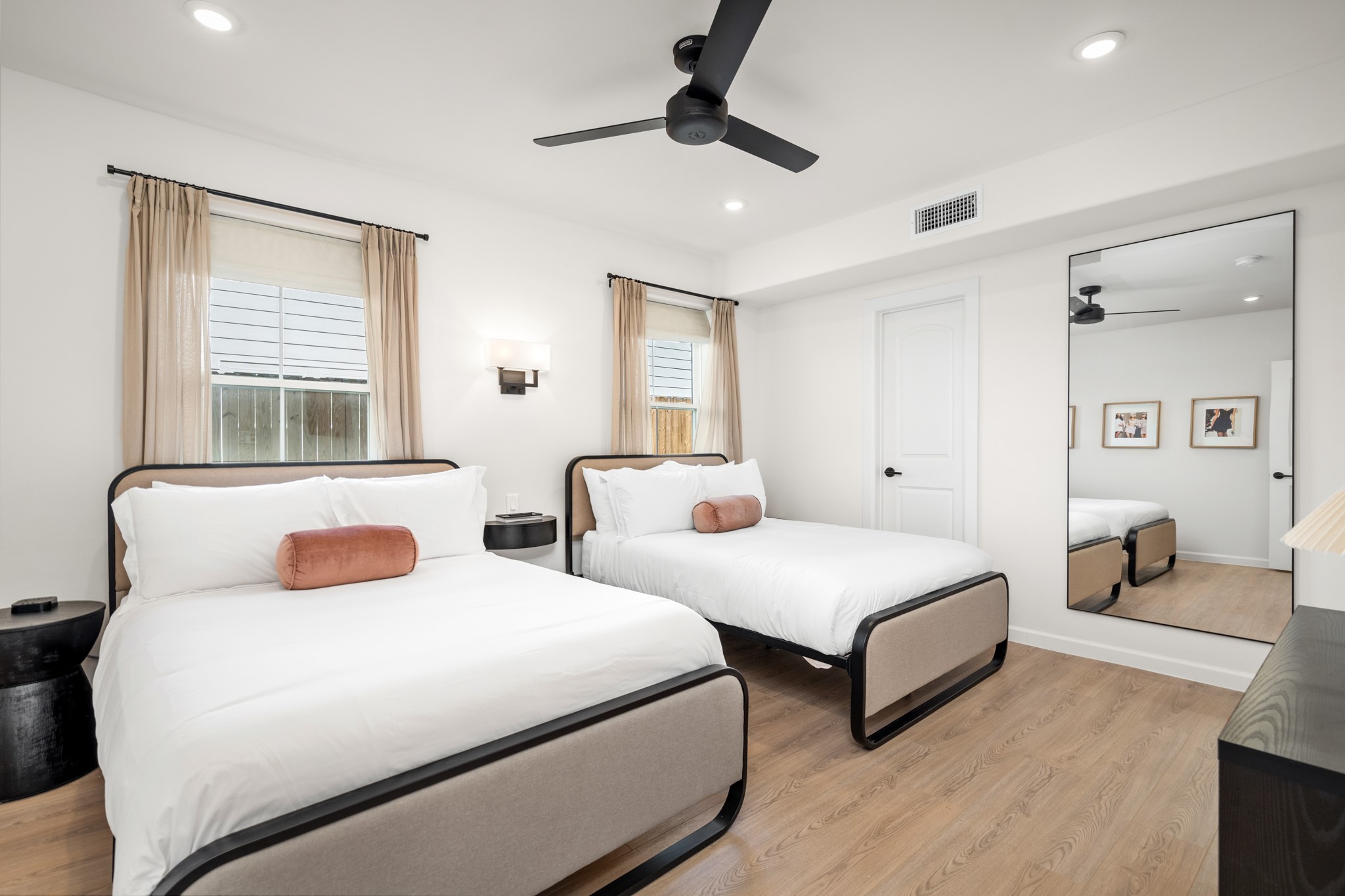 2413 Isabella Street Houston, TX 77004 - Photo 22 of 50 a bedroom with two beds and a chandelier