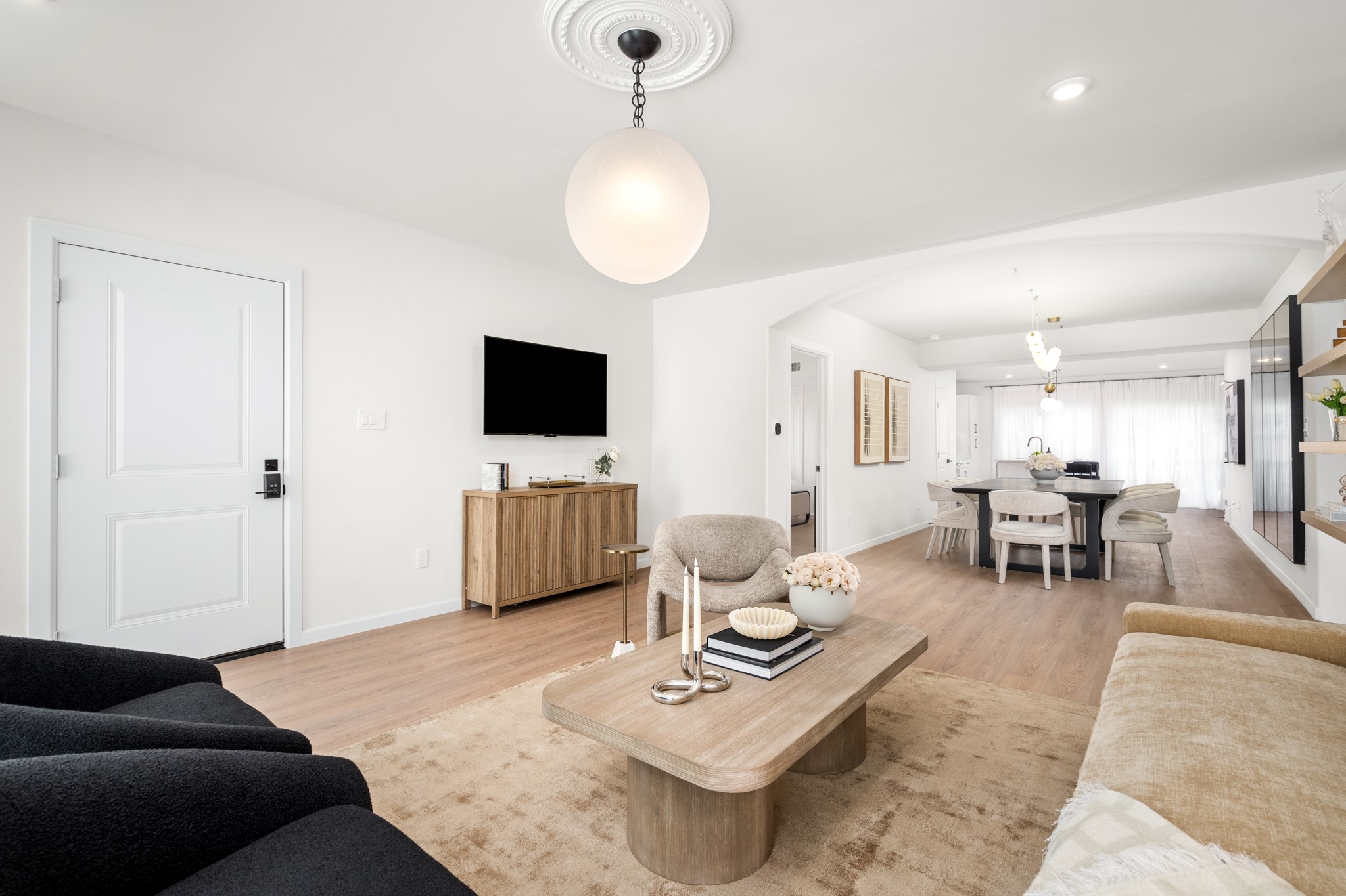 2413 Isabella Street Houston, TX 77004 - Photo 4 of 50 a living room with furniture a flat screen tv and kitchen view