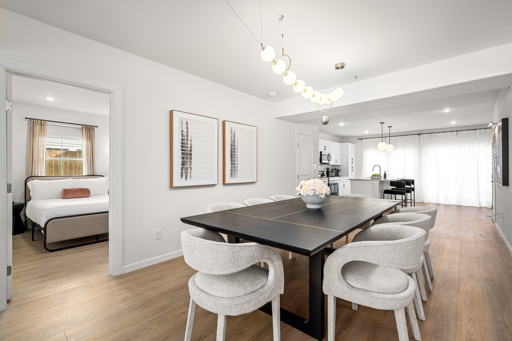 2413 Isabella Street Houston, TX 77004 - Photo 7 of 50 a kitchen with a dining table chairs and white cabinets