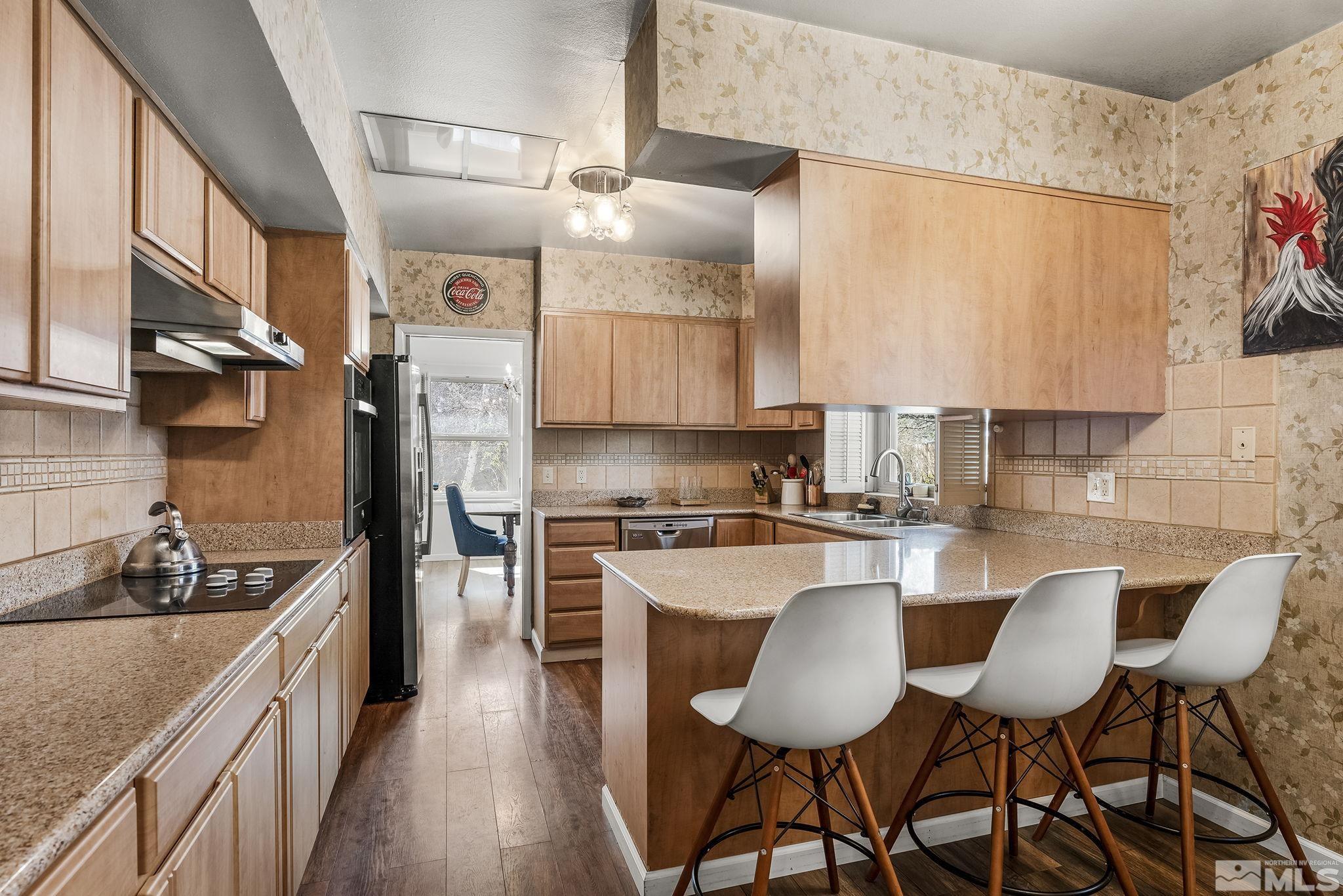 2690 Fair Circle Reno, NV 89503 - Photo 8 of 40 a kitchen with stainless steel appliances a sink a stove top oven a counter space and cabinets