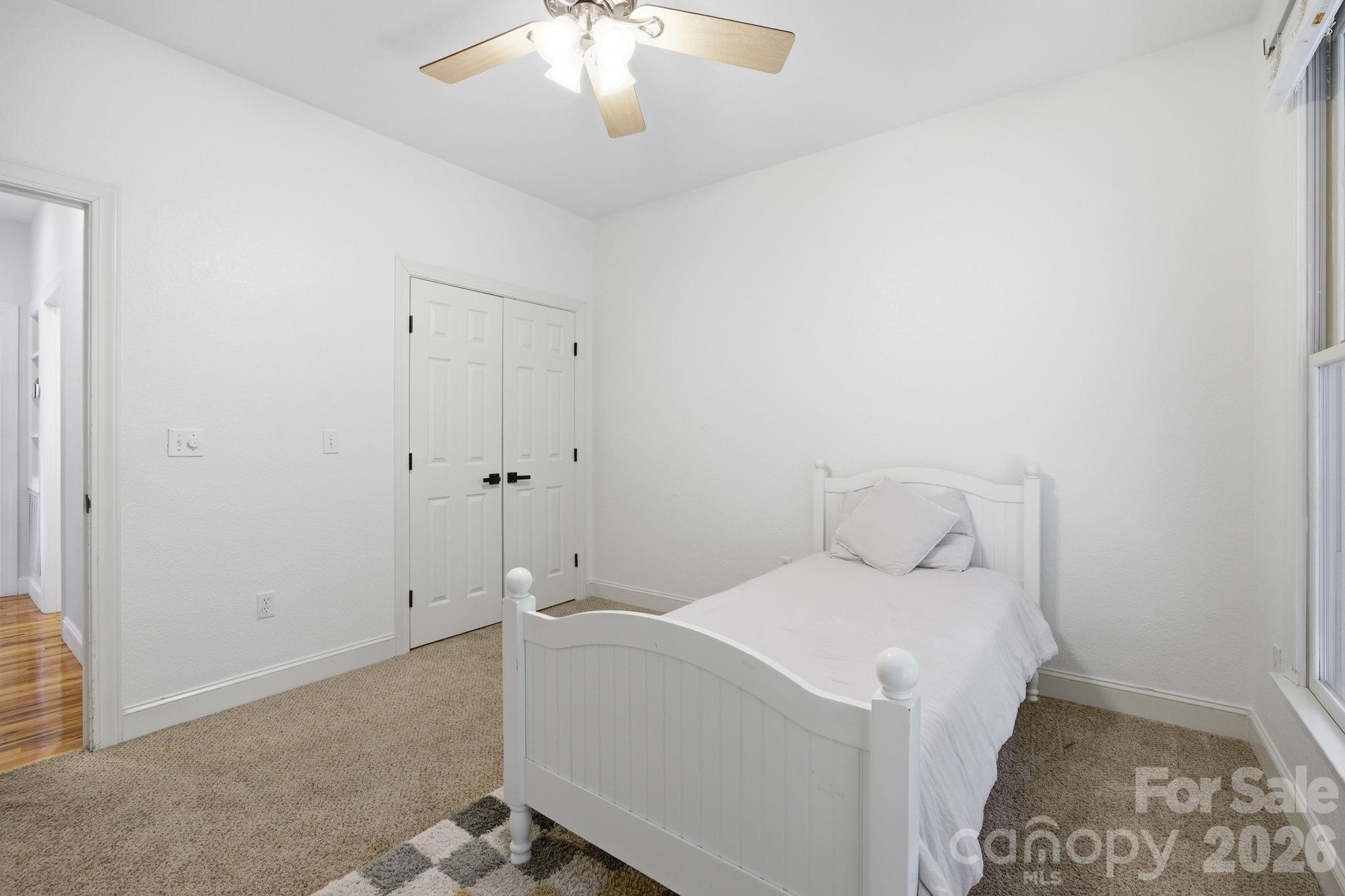 612 Christian Creek Road Swannanoa, NC 28778 - Photo 18 of 37 a room with a bed and a chandelier