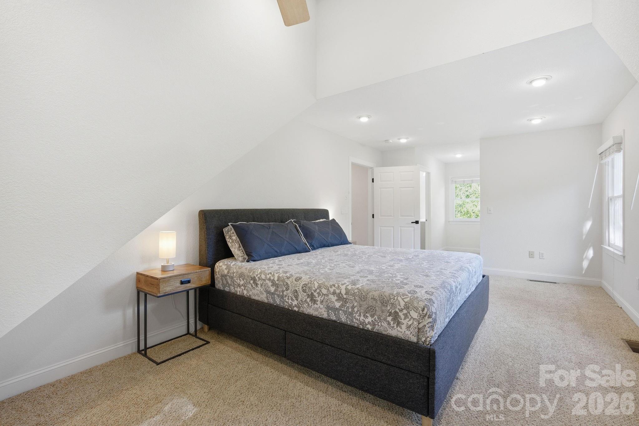 612 Christian Creek Road Swannanoa, NC 28778 - Photo 23 of 37 a spacious bedroom with a bed and a cabinets