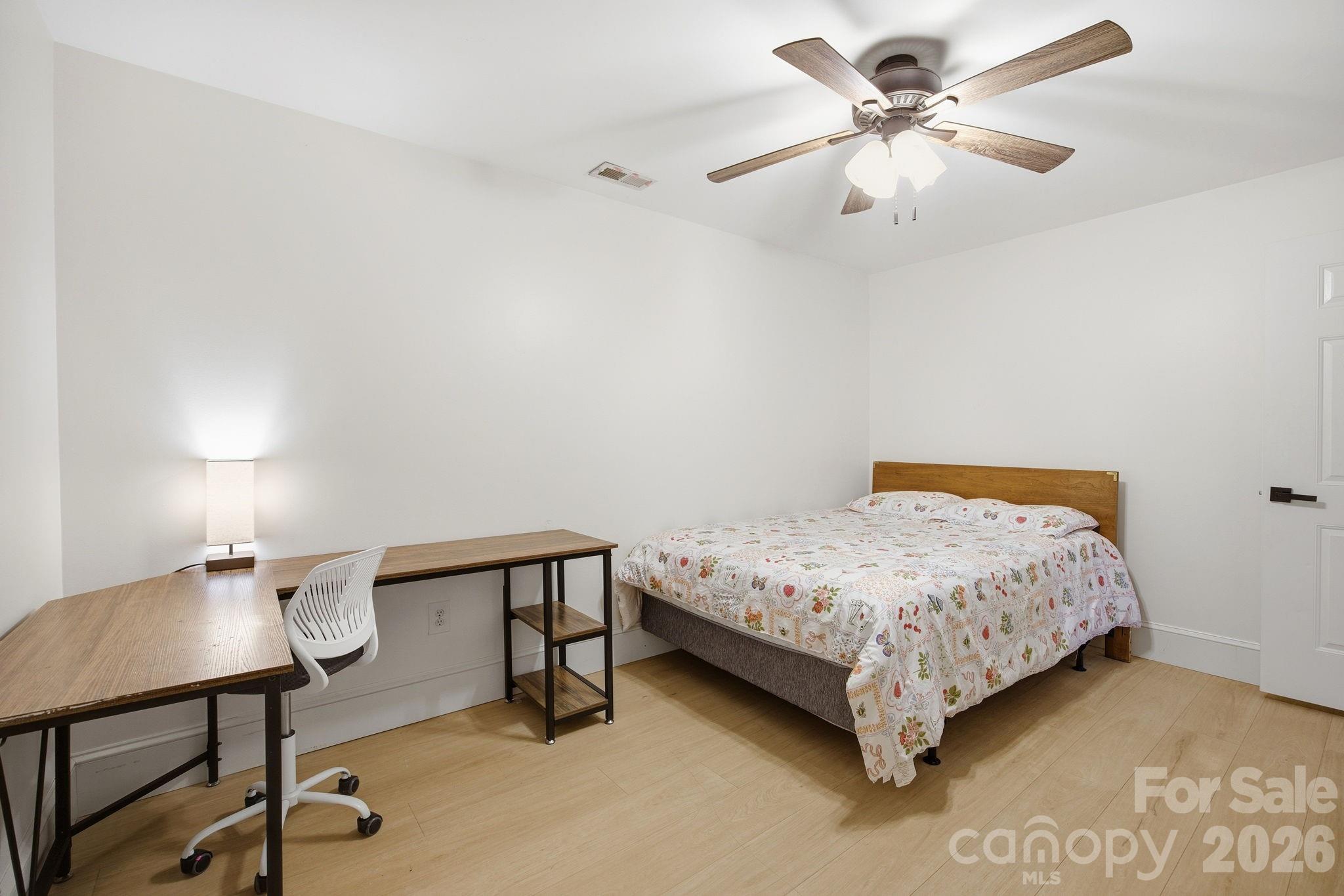 612 Christian Creek Road Swannanoa, NC 28778 - Photo 27 of 37 a bedroom with a bed a lamp on the table and a chandelier