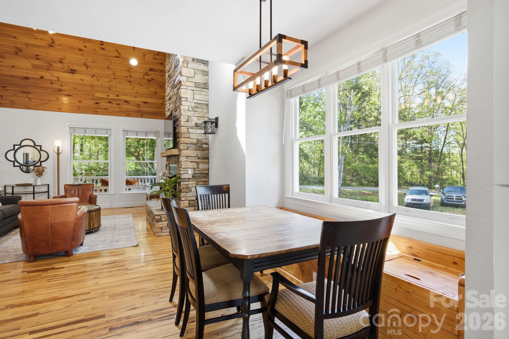 612 Christian Creek Road Swannanoa, NC 28778 - Photo 9 of 37 a dining room with furniture a chandelier and wooden floor