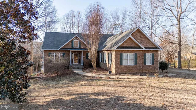 a front view of a house with a yard covered in snow