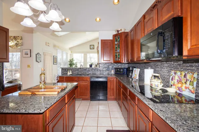 a dining room with furniture a potted plant and wooden floor
