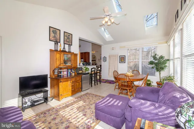 a bedroom with a bed and a lamp on dresser