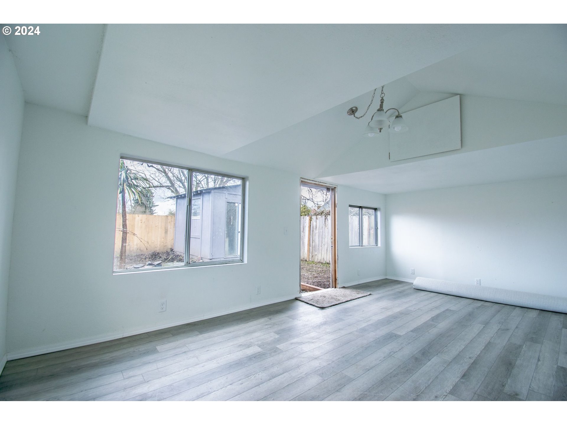 247 37th Street Springfield, OR 97478 - Photo 26 of 30 a view of an empty room with wooden floor and windows