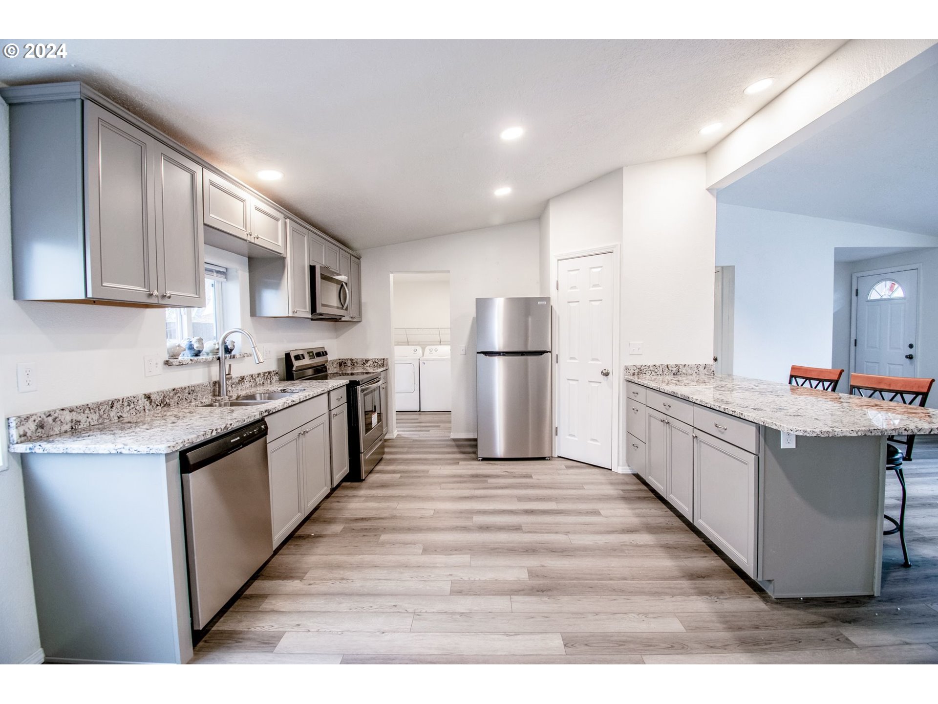 247 37th Street Springfield, OR 97478 - Photo 8 of 30 a large kitchen with stainless steel appliances a refrigerator and a stove top oven