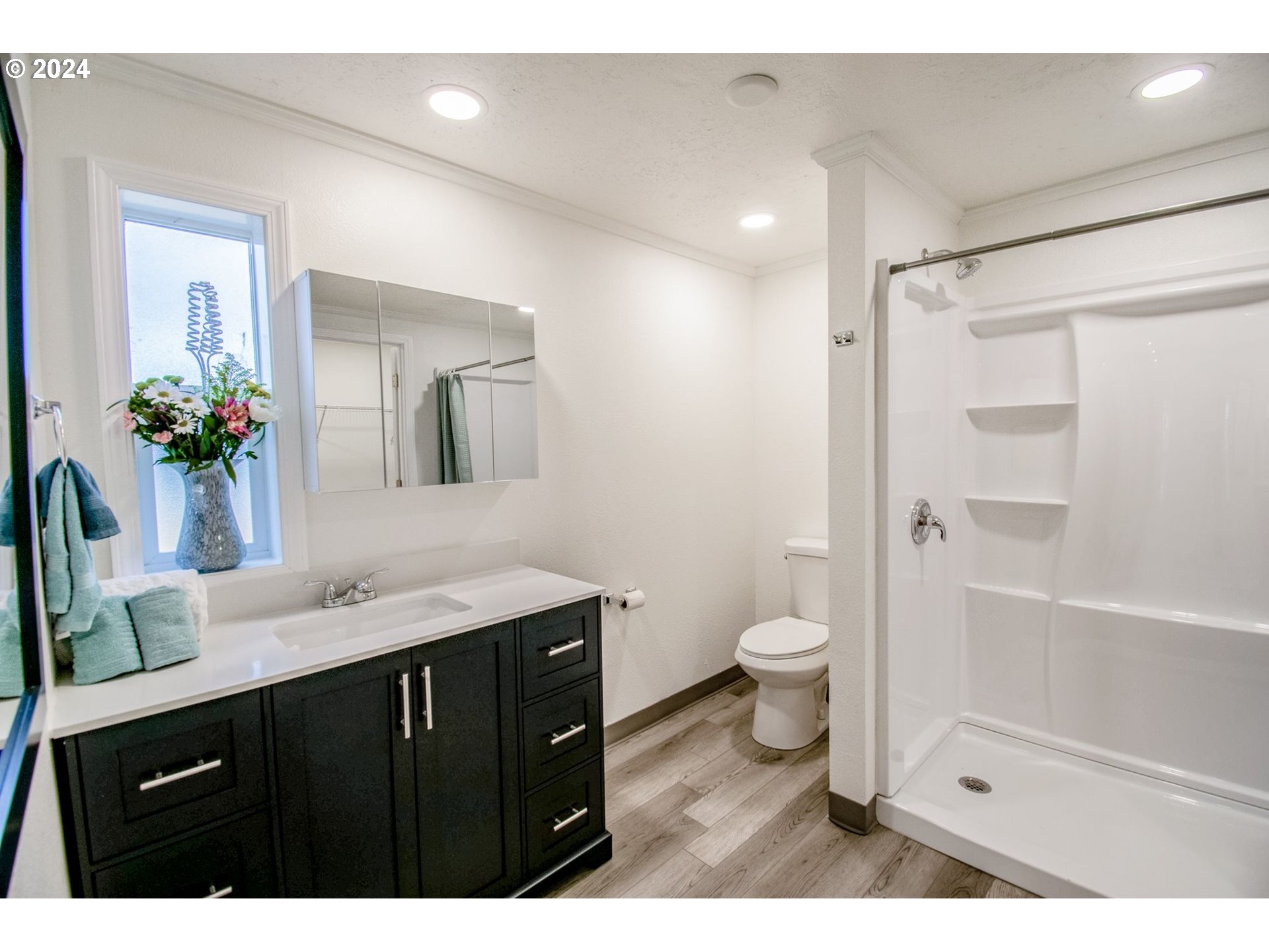 247 37th Street Springfield, OR 97478 - Photo 9 of 30 a bathroom with a granite countertop sink toilet a large mirror and shower
