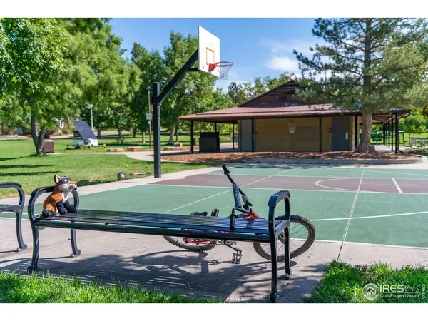 a view of a tennis room with lounge chair and a table