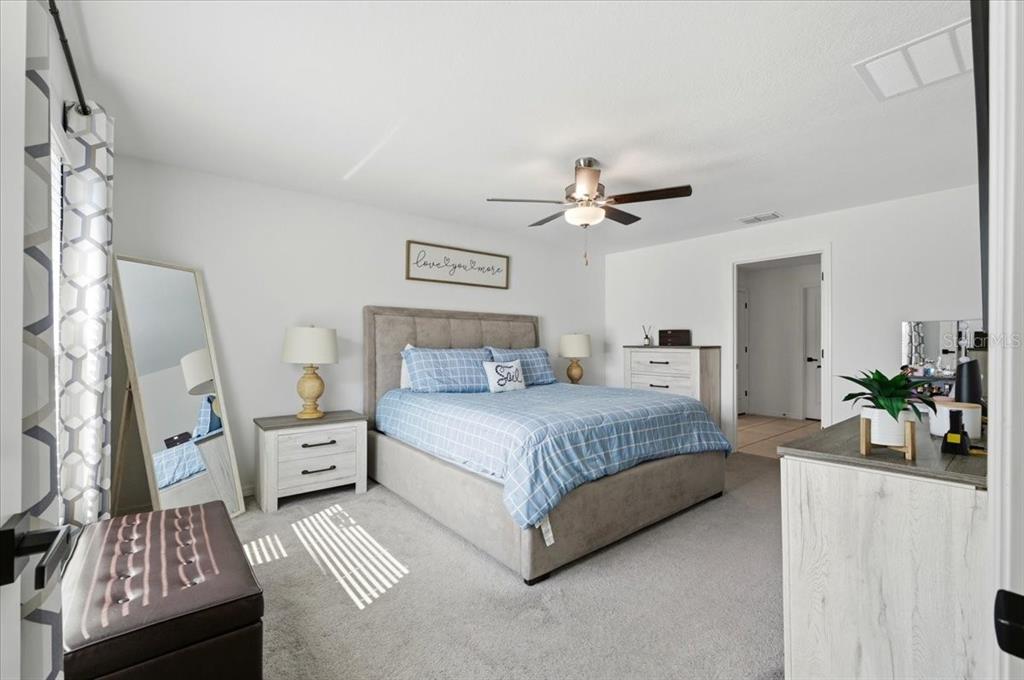 1923 Red Loop Lakeland, FL 33801 - Photo 23 of 51 a spacious bedroom with a bed and ceiling fan