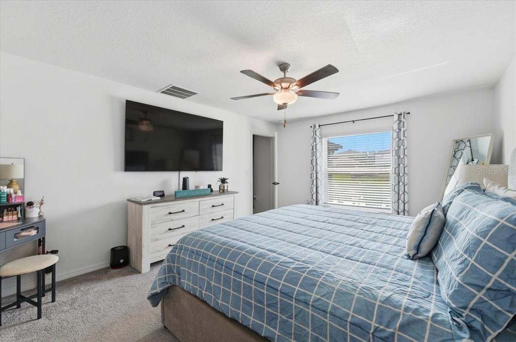 1923 Red Loop Lakeland, FL 33801 - Photo 24 of 51 a bedroom with a bed and a flat screen tv