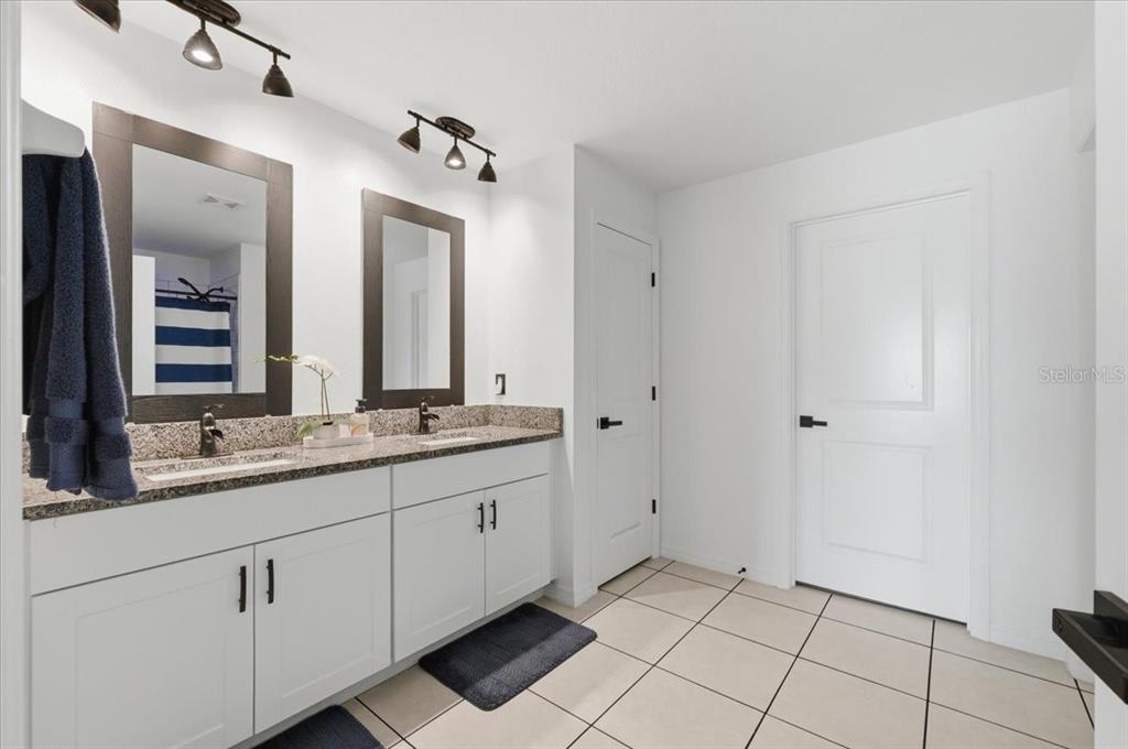 1923 Red Loop Lakeland, FL 33801 - Photo 26 of 51 a bathroom with a double vanity sink and mirror