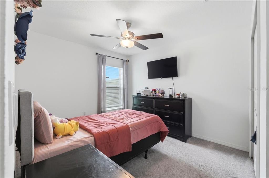 1923 Red Loop Lakeland, FL 33801 - Photo 28 of 51 a bedroom with a bed and a flat screen tv