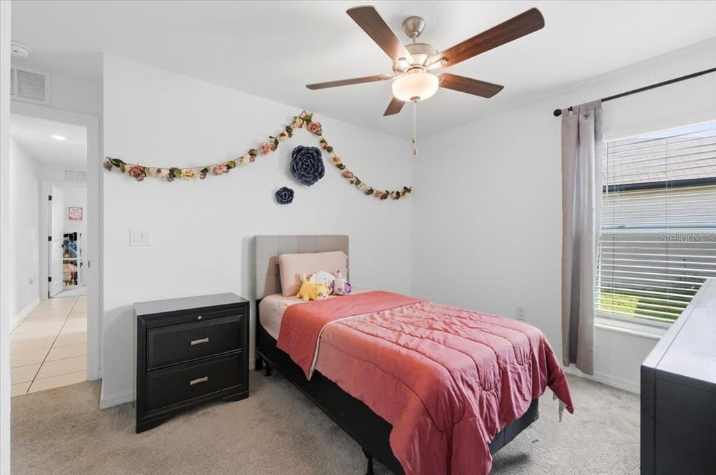 1923 Red Loop Lakeland, FL 33801 - Photo 29 of 51 a bedroom with a bed and a chandelier