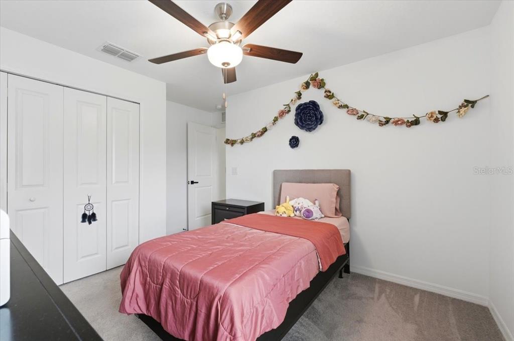 1923 Red Loop Lakeland, FL 33801 - Photo 30 of 51 a bedroom with a bed and a chandelier