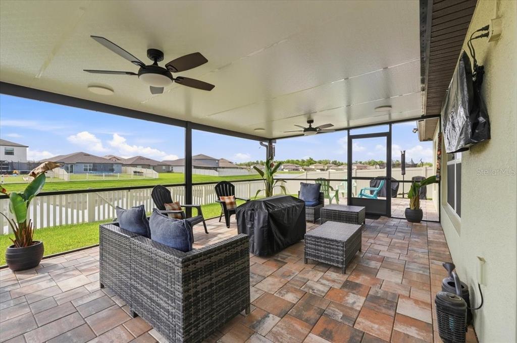 1923 Red Loop Lakeland, FL 33801 - Photo 39 of 51 a living room with large windows a rug and a chandelier