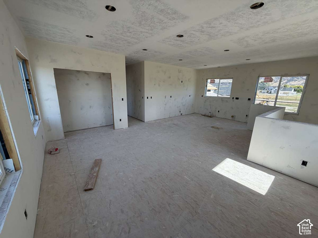 338 West 3400 South Logan, UT 84321 - Photo 37 of 40 Recessed ceiling lighting, multiple windows, interior walls with drywall, partially finished interior, and an exposed subfloor