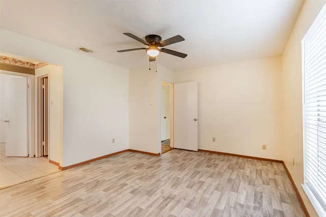 a view of room with hardwood floor and ceiling fan