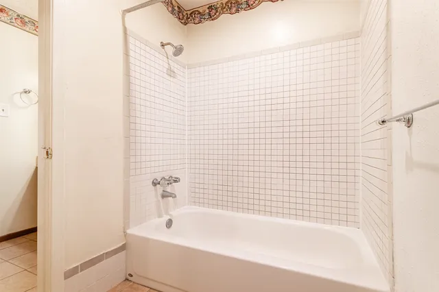 a bathroom with a bathtub and shower