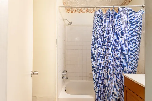 a bathroom with a shower curtain and a sink