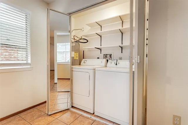 a utility room with cabinets washer and dryer