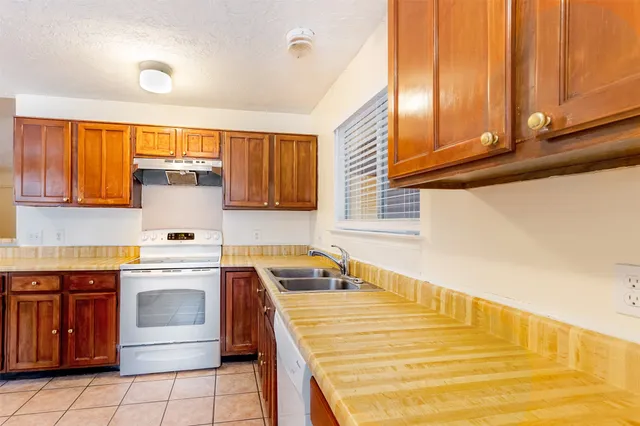 a kitchen with a stove and a sink