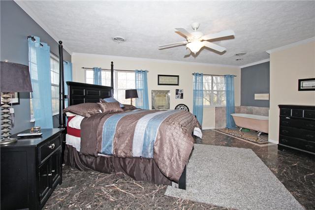 3330 Ott Wilson Road Springfield, TN 37172 - Photo 6 of 17 a bed room with a bed and a ceiling fan