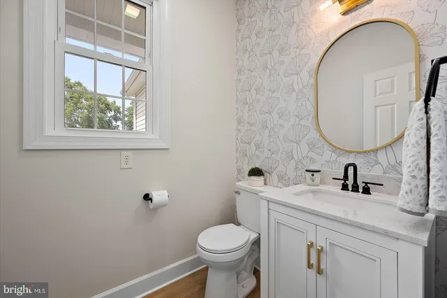 an empty room with closet and a chandelier fan