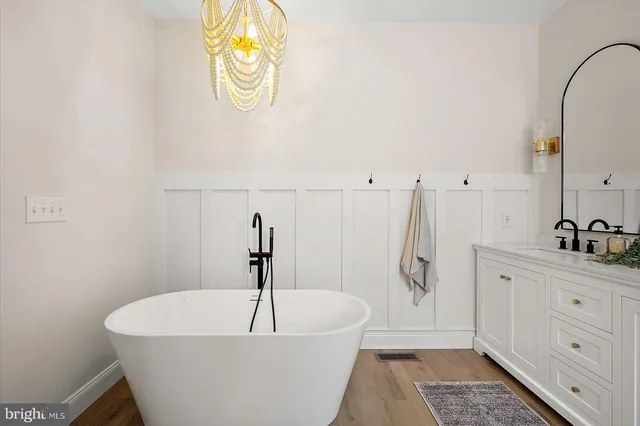a front view of a house with a yard and potted plants
