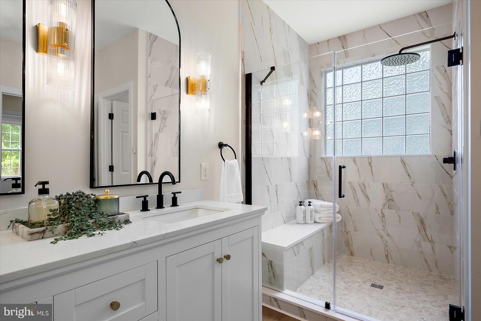 26161 Bosch Lane Hebron, MD 21830 - Photo 5 of 49 a bathroom with a double vanity sink mirror and shower