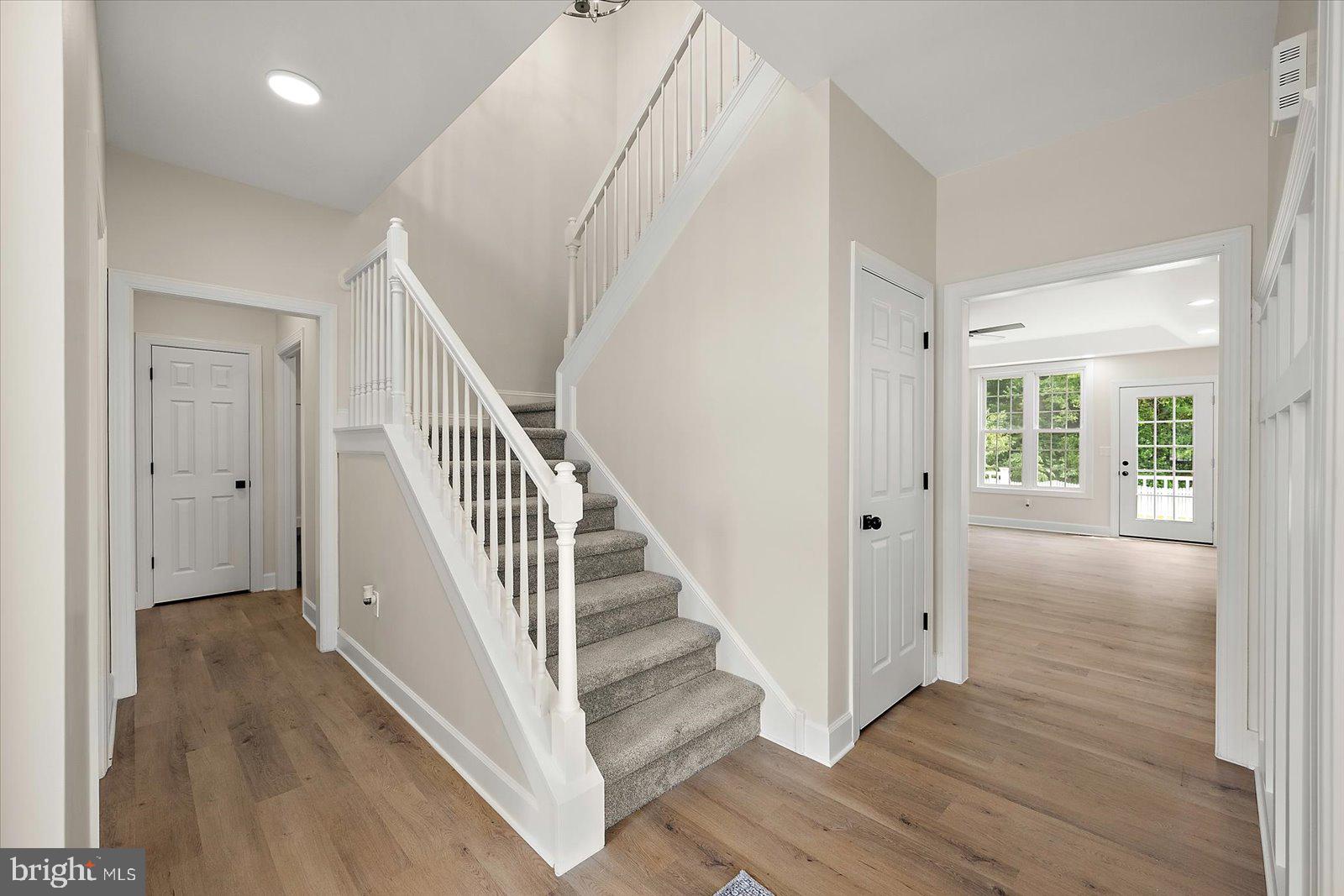 26161 Bosch Lane Hebron, MD 21830 - Photo 9 of 49 a view of a hallway with wooden floor and entryway