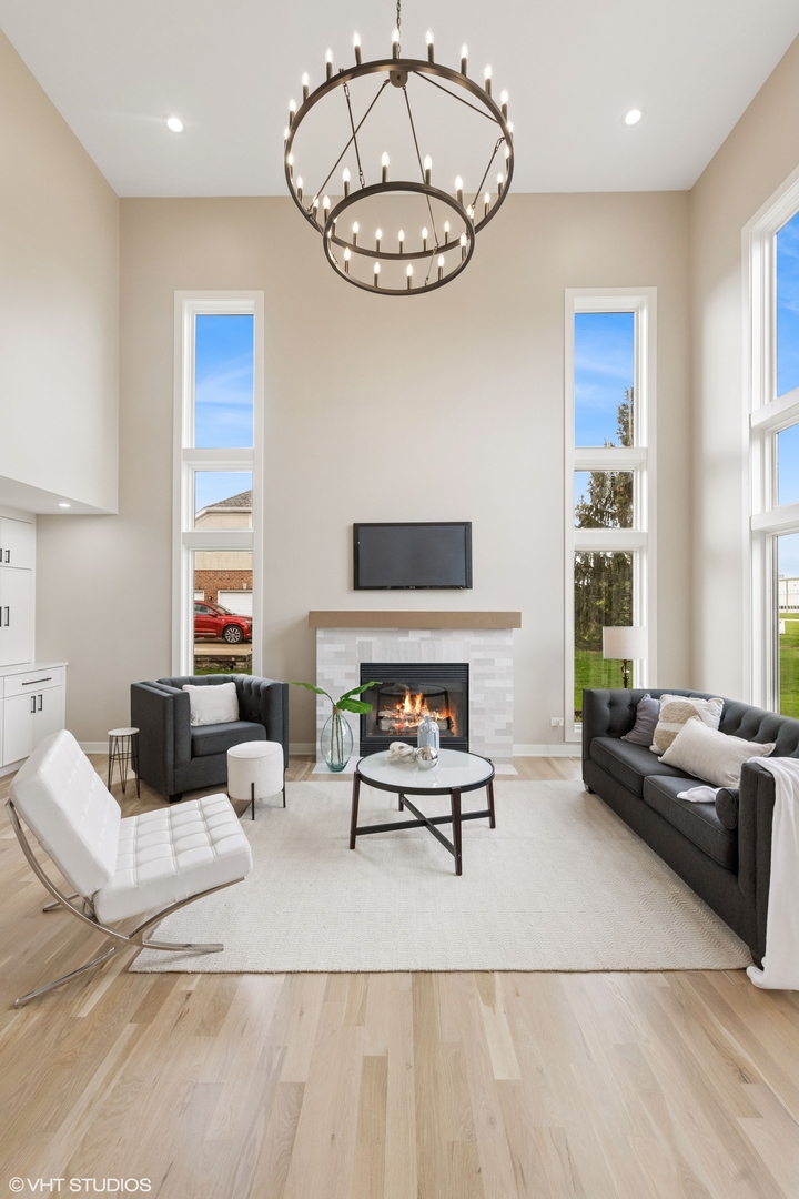 6878 Fieldstone Drive Burr Ridge, IL 60527 - Photo 14 of 45 a living room with furniture a fireplace and a large window