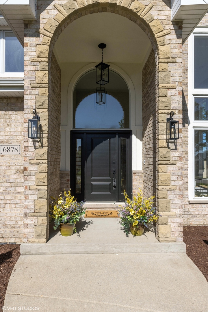 6878 Fieldstone Drive Burr Ridge, IL 60527 - Photo 2 of 45 a front view of a house with a yard