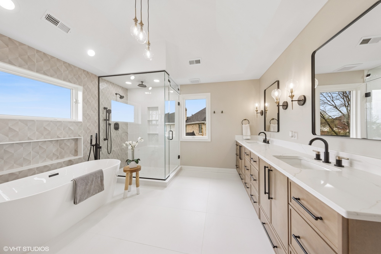 6878 Fieldstone Drive Burr Ridge, IL 60527 - Photo 24 of 45 a bathroom with a double vanity sink a mirror a bathtub and shower