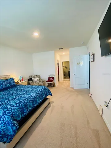 a bed room with a bed and a flat screen tv