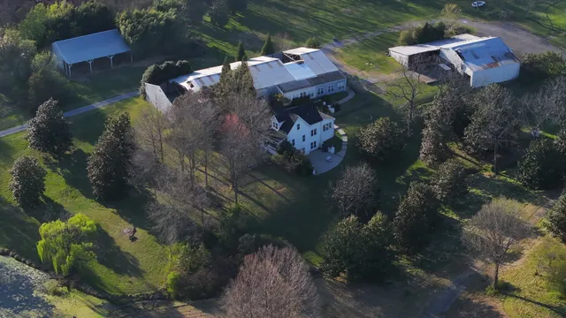 an aerial view of a house with a yard