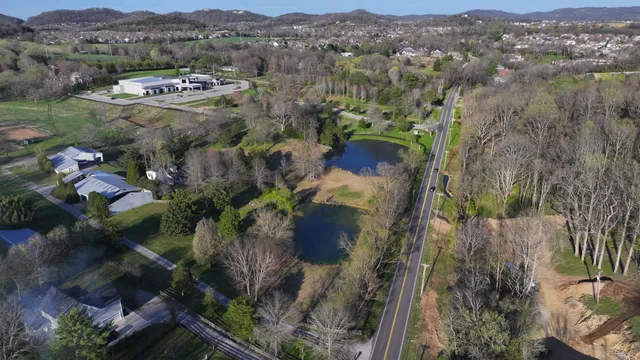an aerial view of mountain with residential house and green space